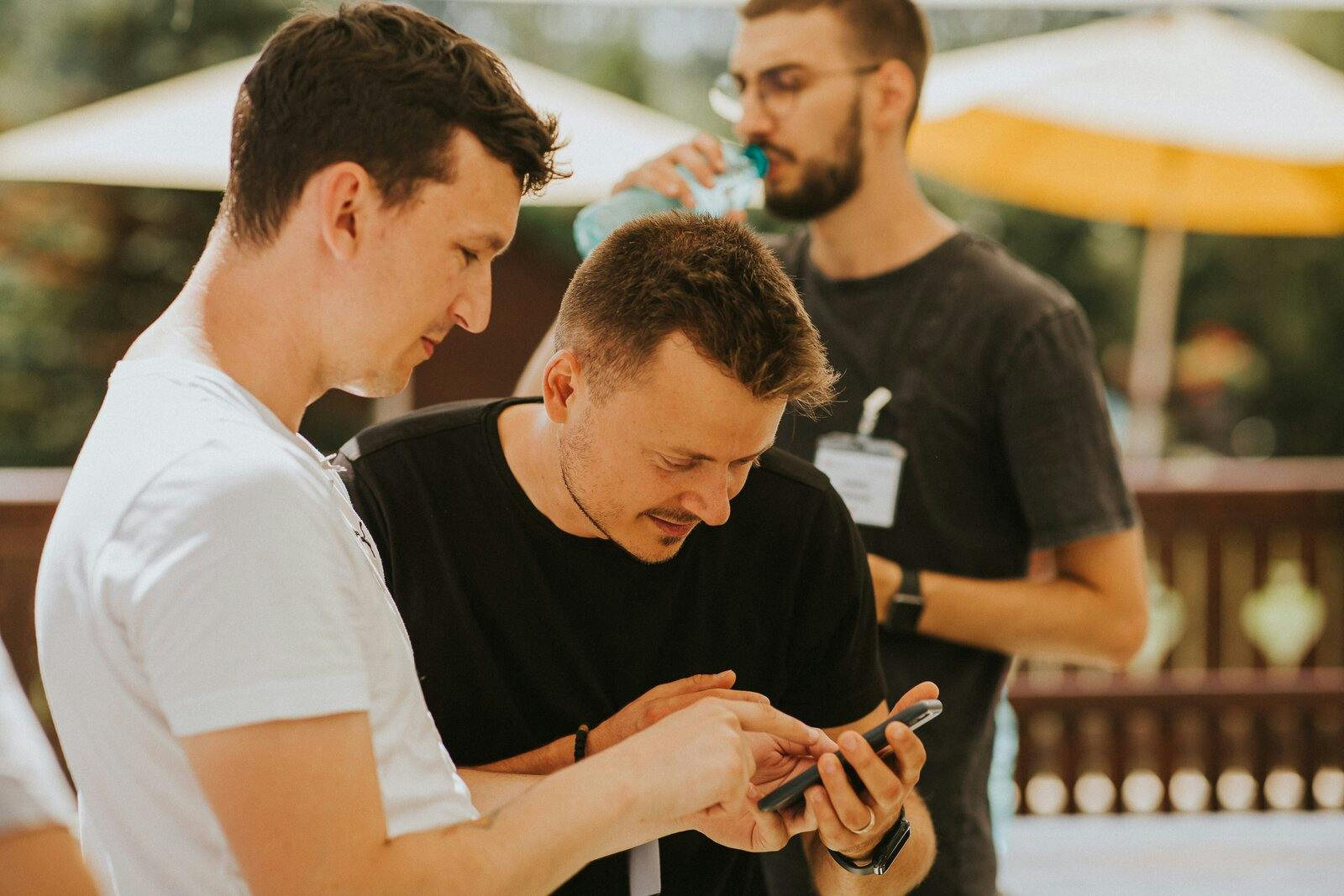 People inspecting an app on a mobile device