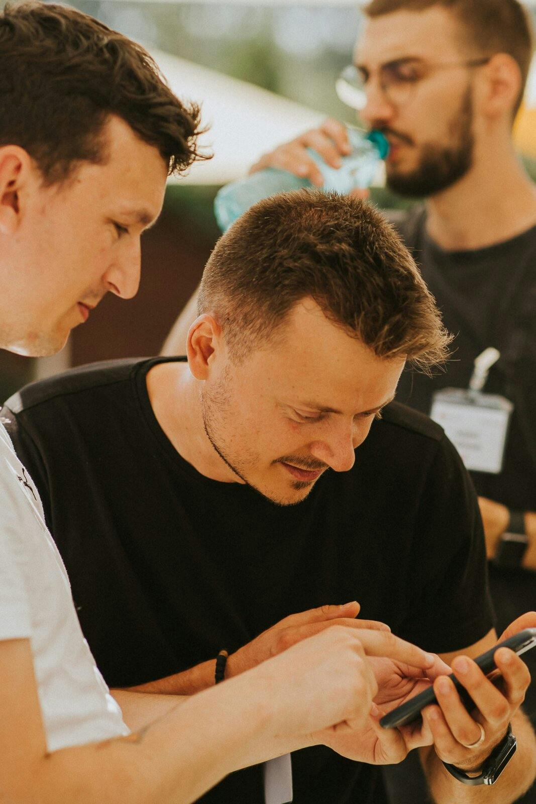 People inspecting an app on a mobile phone